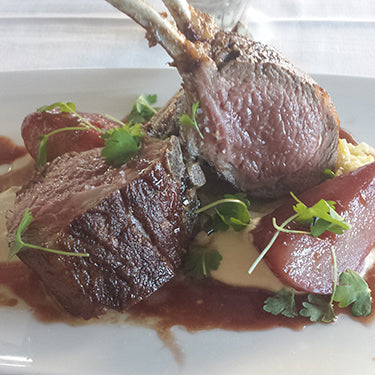 Image of Roasted Rack of Lamb With Celery Root Purée, Leek Soubise Sauce and Pomegranate-Poached Pears