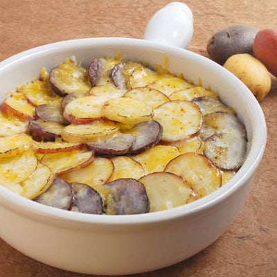 Image of Scalloped Gemstone Potatoes with Caramelized Hatch Sweet Onions