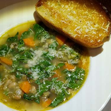 Image of Tuscan-Style White Bean and Garlic Soup with Baby Kale