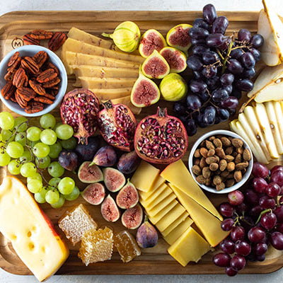 Image of charcuterie platter with cheese, grapes, nuts and pears