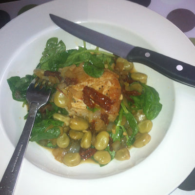 Image of Pork Loin Chops with Fava Beans Caramelized Onions Slivered Tomatoes and Wilted Arugula