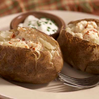 Image of Baked Potatoes with Pepper-Flake Garlic Butter and Sour Cream