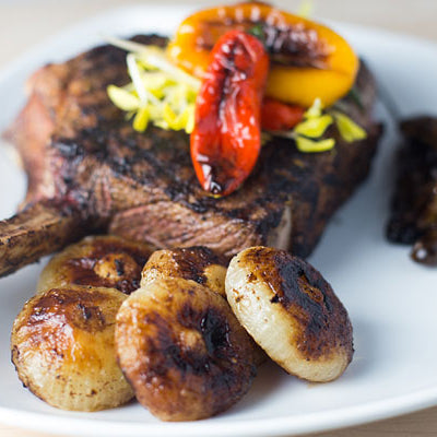 Image of Grilled Bone-In Rib Eye Steaks with Caramelized Cipolline Onions, Pan Seared Veggies