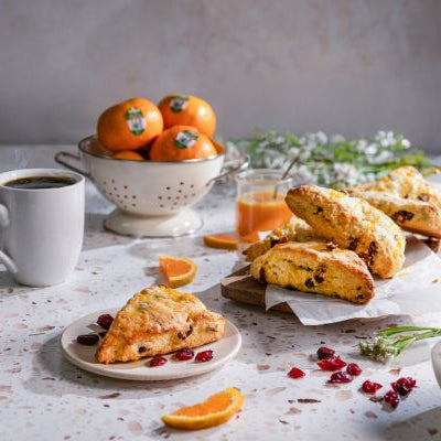 Dried cranberry and Pixie tangerine scones with Pixie tangerine sauce from Melissa’s, a golden, bakery-style treat with vibrant citrus appeal