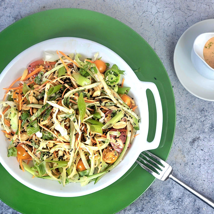 Thai-Style Salad with Shredded Cabbage Carrots Basil Peanuts and Sesame Seeds with Sriracha Lime Dressing