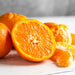 Nadorcott Mandarins sliced and on a wooden surface
