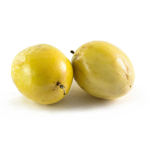 Yellow Passion Fruit on a white surface.